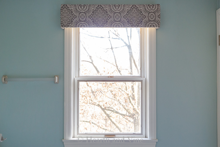 Fabric covered window cornice.