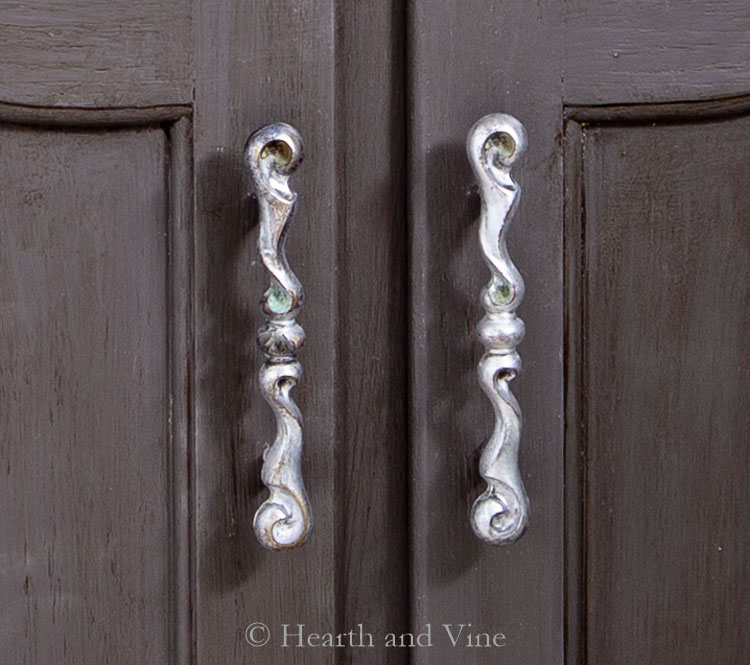 Drawer pulls rubbed with silver into handles