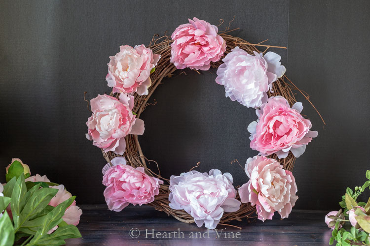 Eight peonies on grapevine wreath