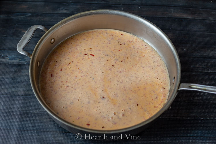 Pureed creamy red pepper sauce in pan