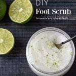 Foot scrub in jar next to sliced limes