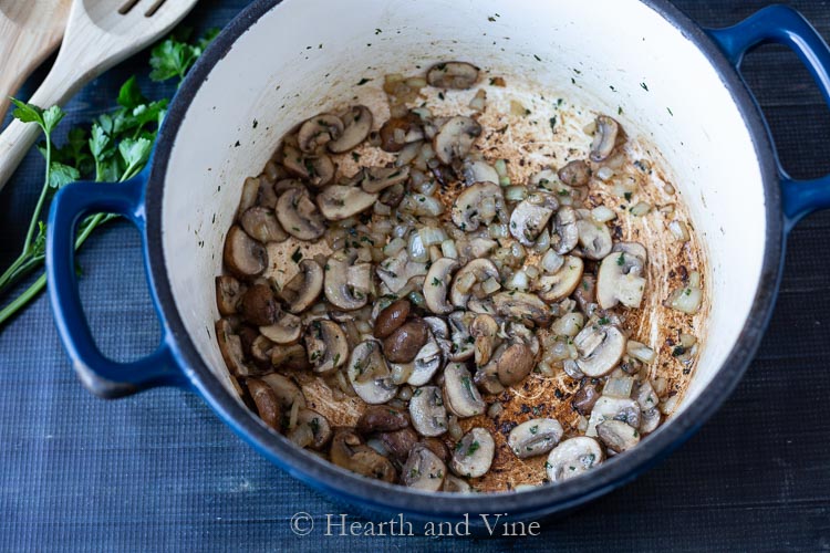 Saute pan with mushrooms, onions, garlic, parsley