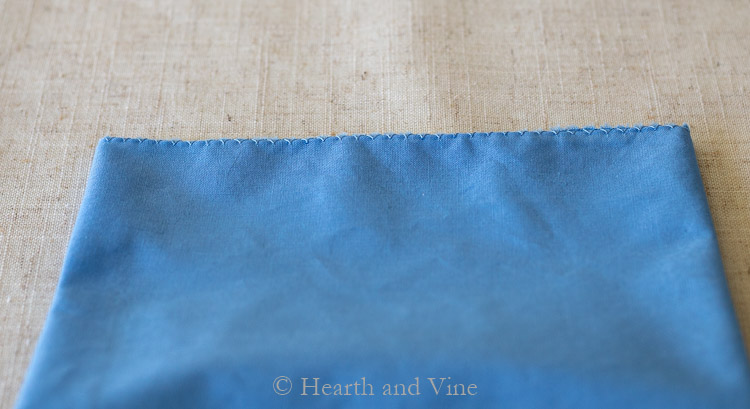 Overcast stitch on blue napkin