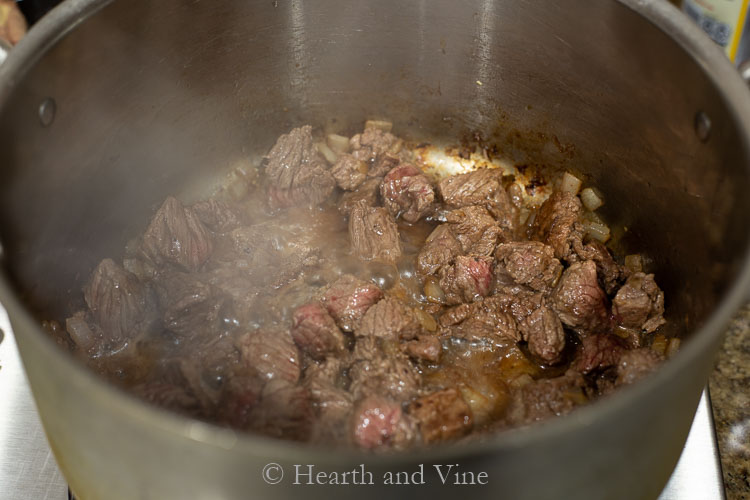 Beef cubes sauteed in large pot