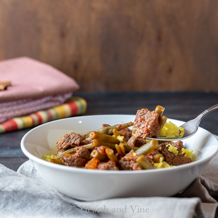 bowl of green Lebanese green bean and beef stew over rice