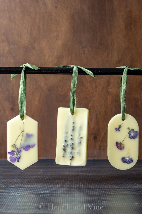 3 homemade fragrant sachets hanging on a rod