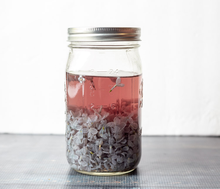 Lilac blossoms and water in mason jar