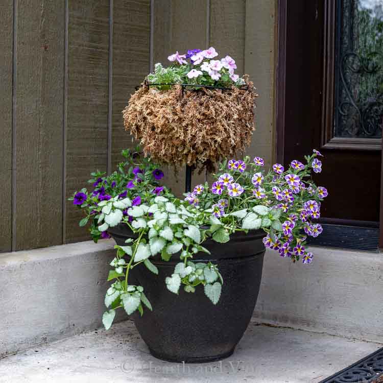 A two tiered flower planter on porch