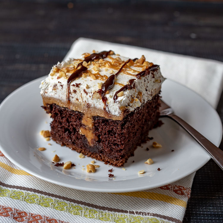 Chocolate peanut butter poke cake cutting