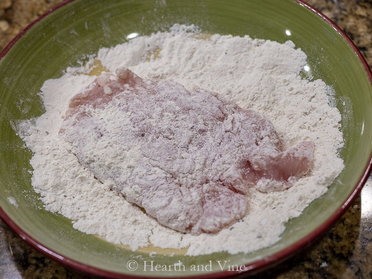 Dredging chicken in flour