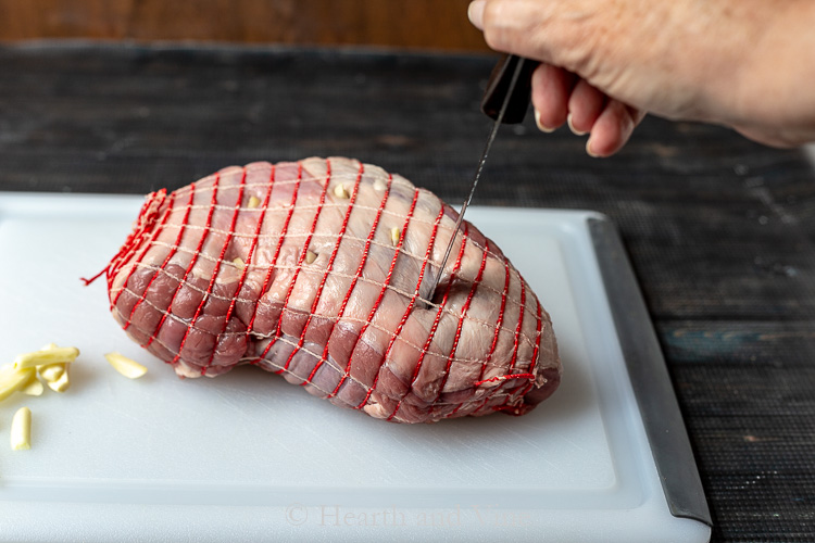 Cutting slits in lamb roast