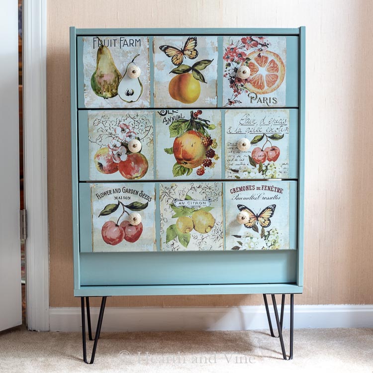 Decorated dresser with botanical print drawer fronts and hairpin legs.