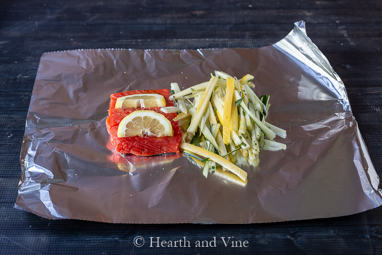 Salmon with lemon slices and veggies on foil