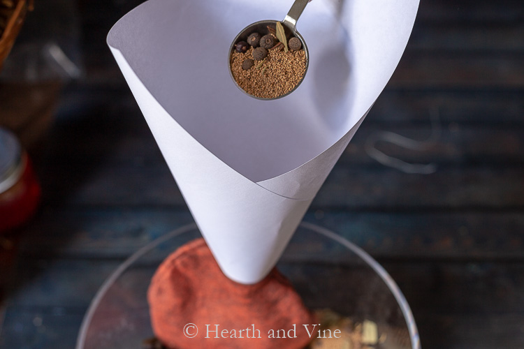 Stuffing pumpkin with filling and paper funnel