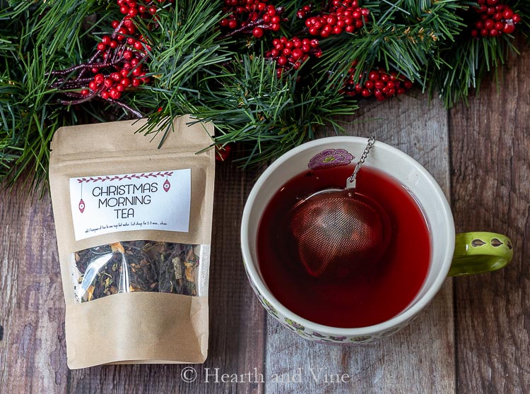 Bag of Christmas morning tea blend and teacup with tea and tea ball