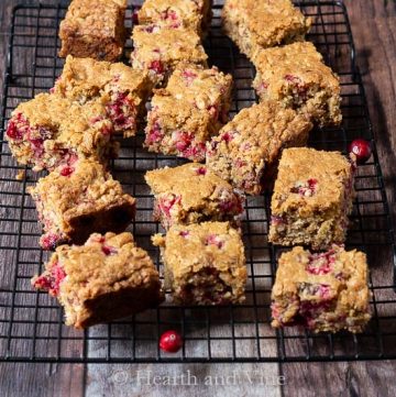 Fresh cranberry oatmeal bars on a cooking rack