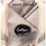 Thanksgiving word stone on linen napkin place setting