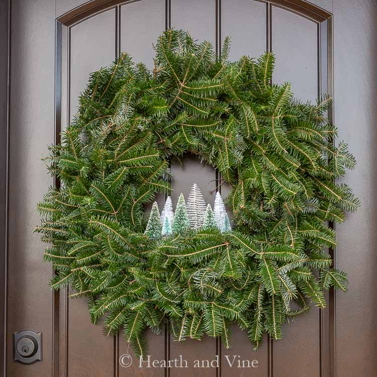 Bottle brush trees in an evergreen wreath