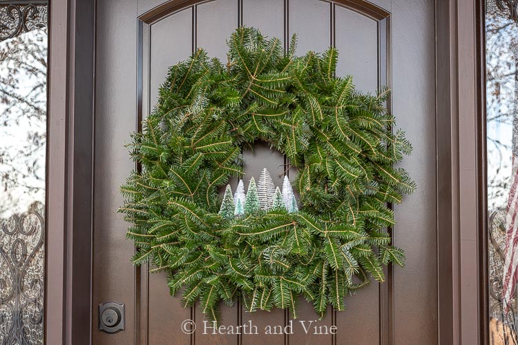 Bottle brush tree wreath on front door