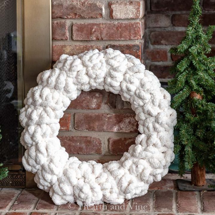 Chunky yarn wreath on hearth