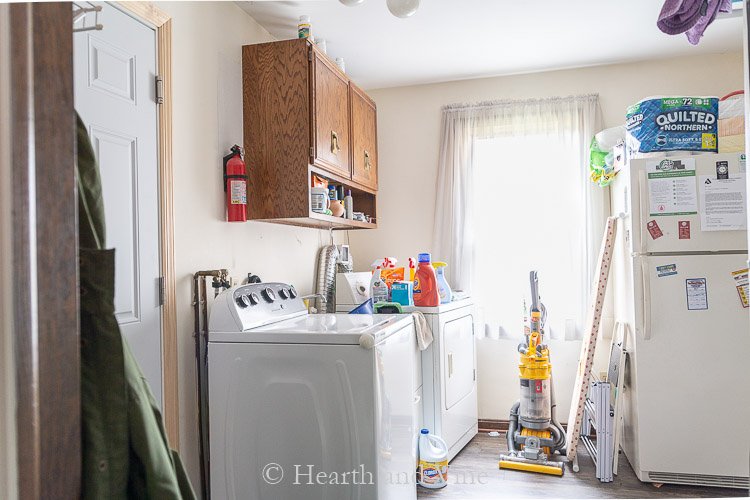 Laundry room makeover before image from kitchen