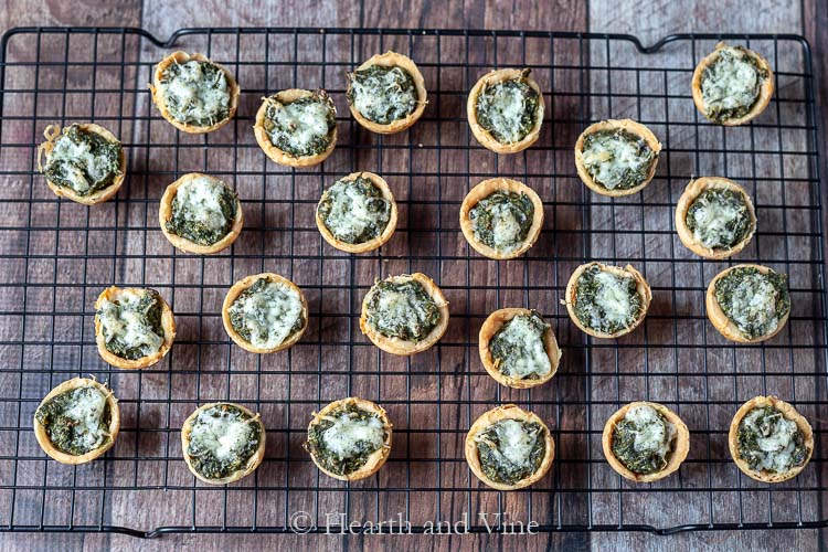 Cheesy spinach muffins cooking on rack