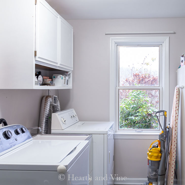 Laundry room cabinet and window painted white