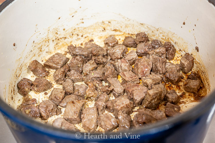 Browning beef cubes in pot