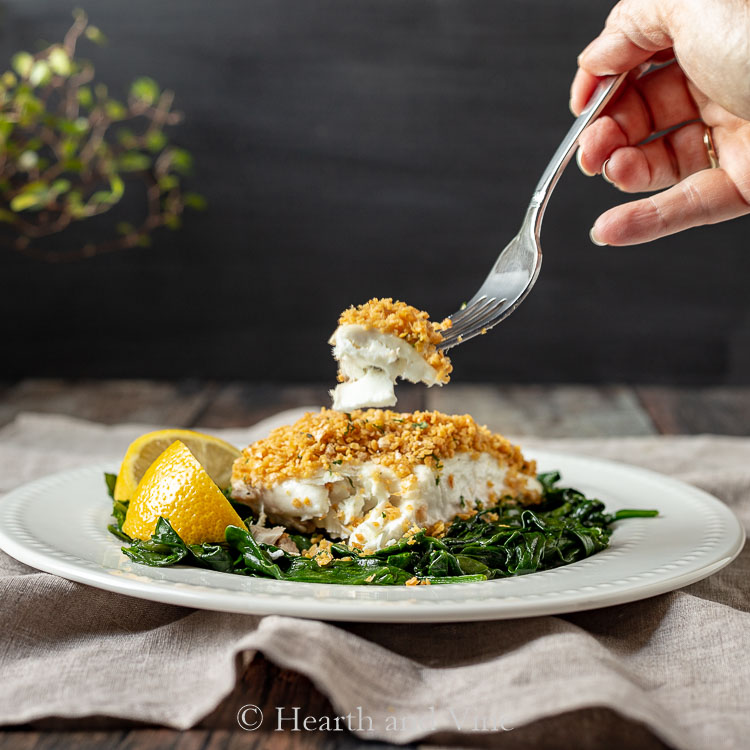 Fork of baked halibut with chickpea crumb topping.