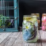 Mason jar oil candle with blue flowers