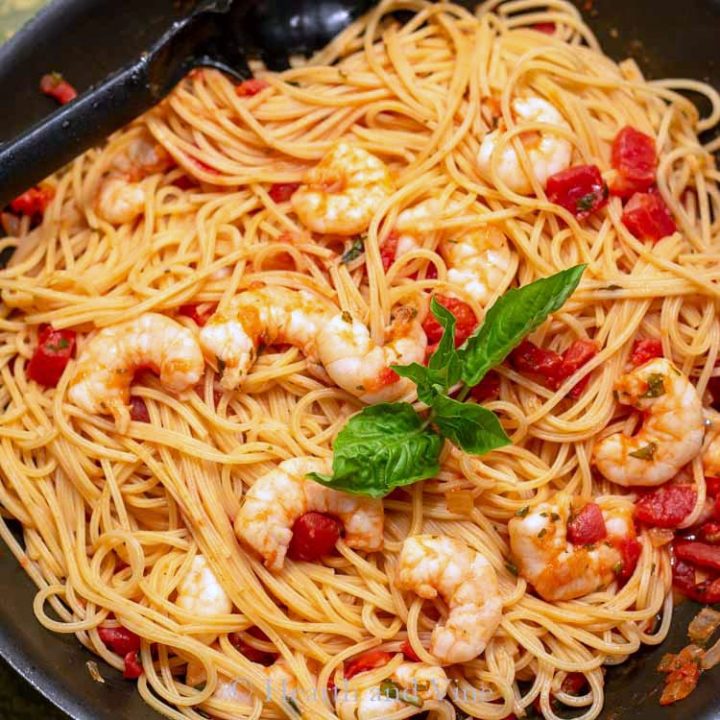 Shrimp and tomato pasta in skillet