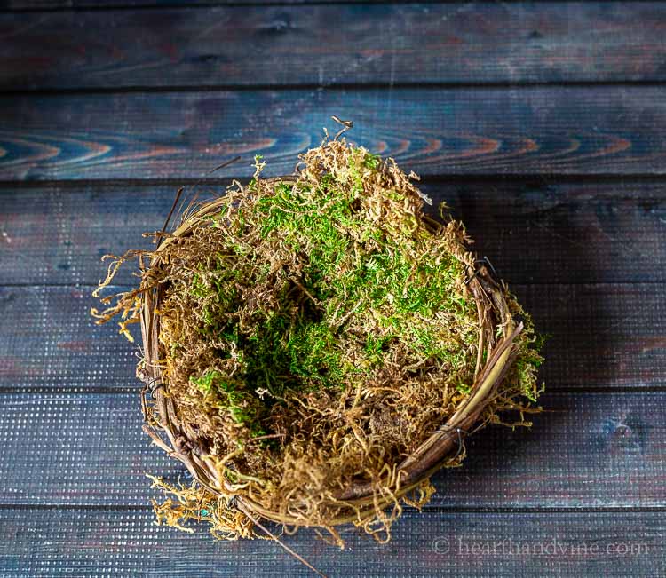 filler and moss in grapevine basket