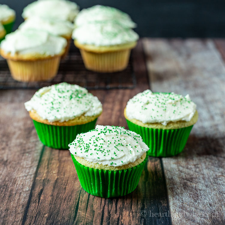 Three cupcakes with green sprinkles