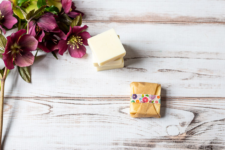 Square lotion bar wrapped in parchment paper