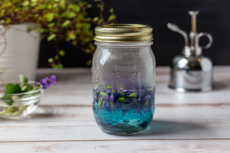 Violets in mason jar with boiling water