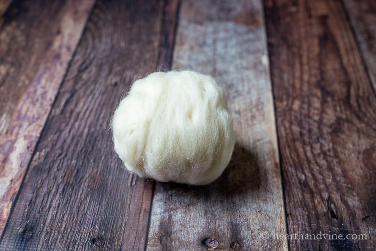 Finished natural wool roving ball.