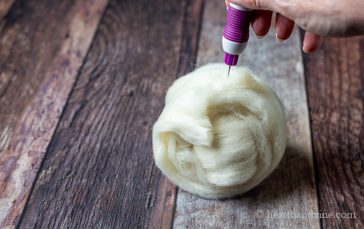Finishing up the wool roving ball with a felting pen