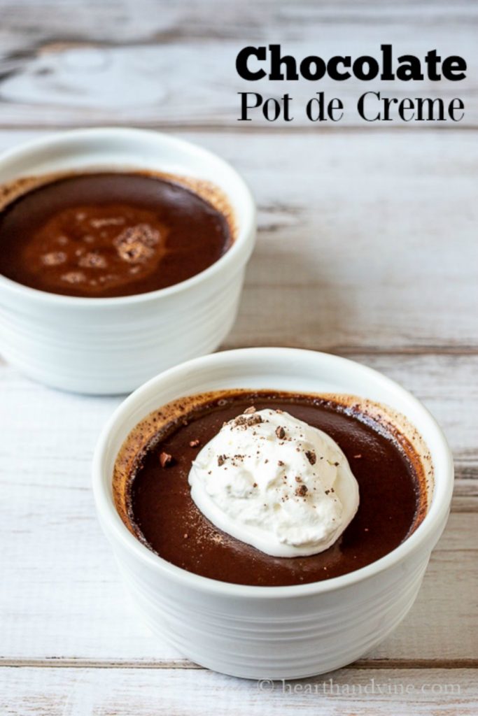 Two ramekins of chocolate pots de creme and text overlay. One is plain and the other has some whipped cream and chocolate bits on top.
