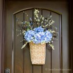 Summer floral basket wreath on front door.