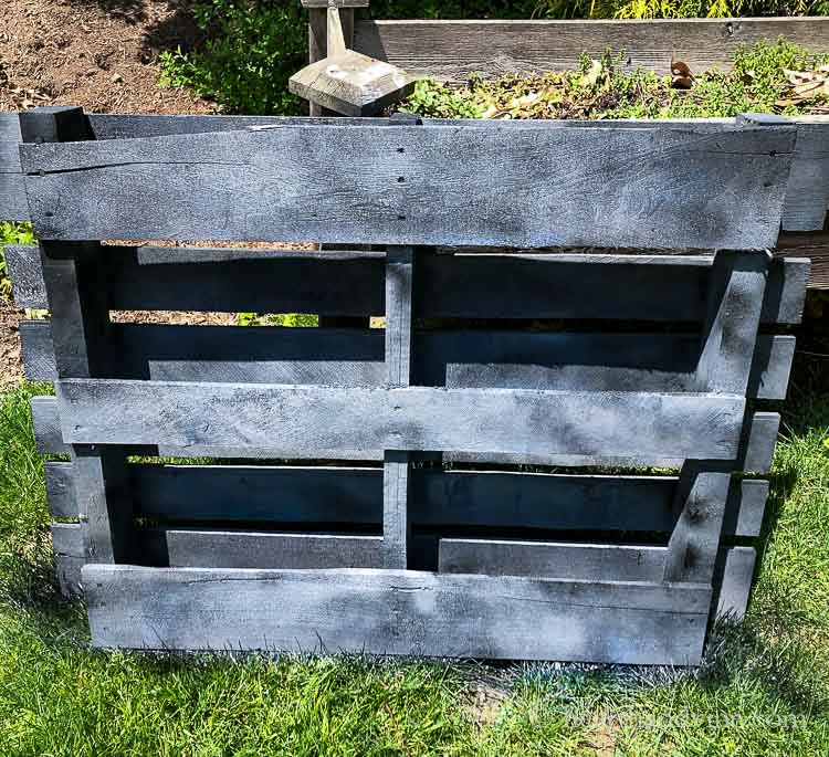 Spray painted wood pallet in shades of gray and black