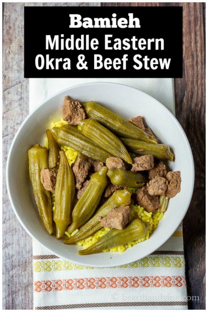 Okra and beef stew over rice in a bowl.