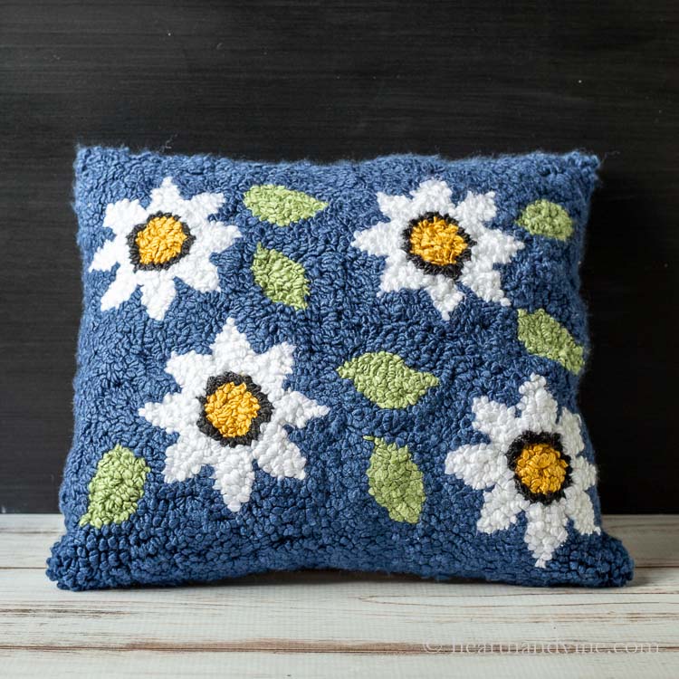 Floral rug hooked pillow.