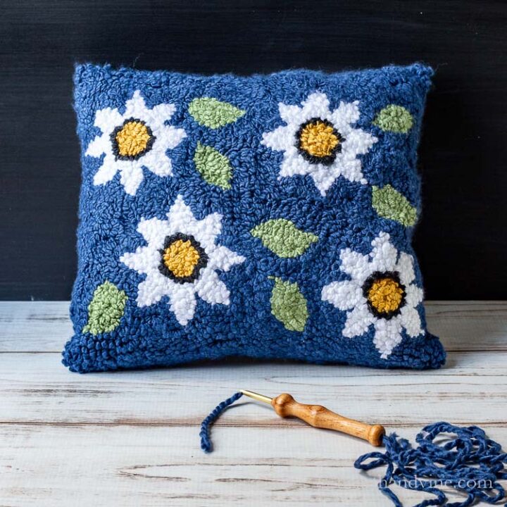 Punch needle rug pillow with floral pattern