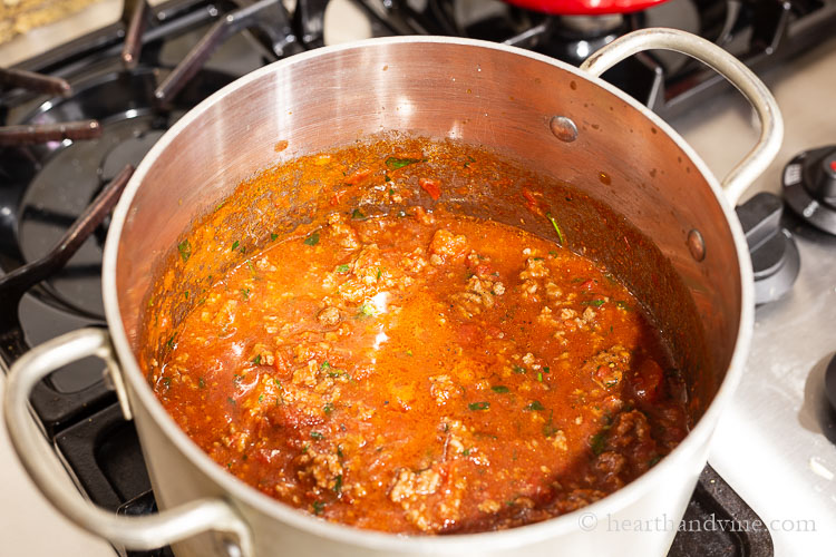 Meat sauce simmering in a saucepan.