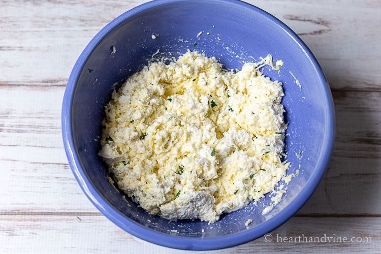Bowl of cheese filling for pasta shells.