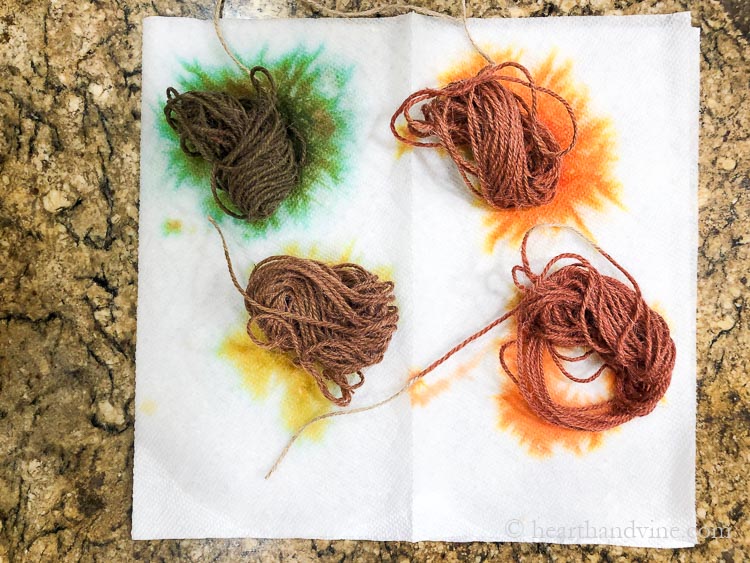 Dyed twine in shades of green, red, orange and brown.