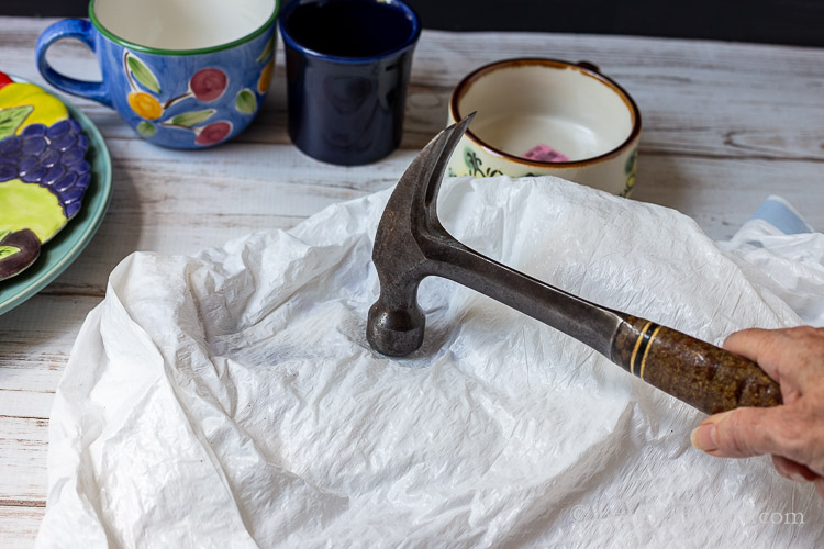 Ceramics in a plastic bag crushed with a hammer.