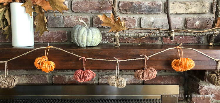 Fall mantel with multi-colored twine pumpkin garland.