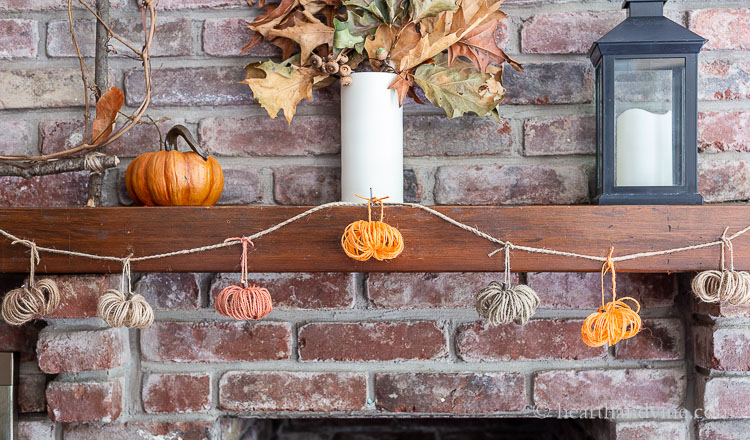 Fall mantel with twine pumpkin garland.