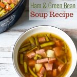 Bowl of ham and green bean soup next to the entire pot.